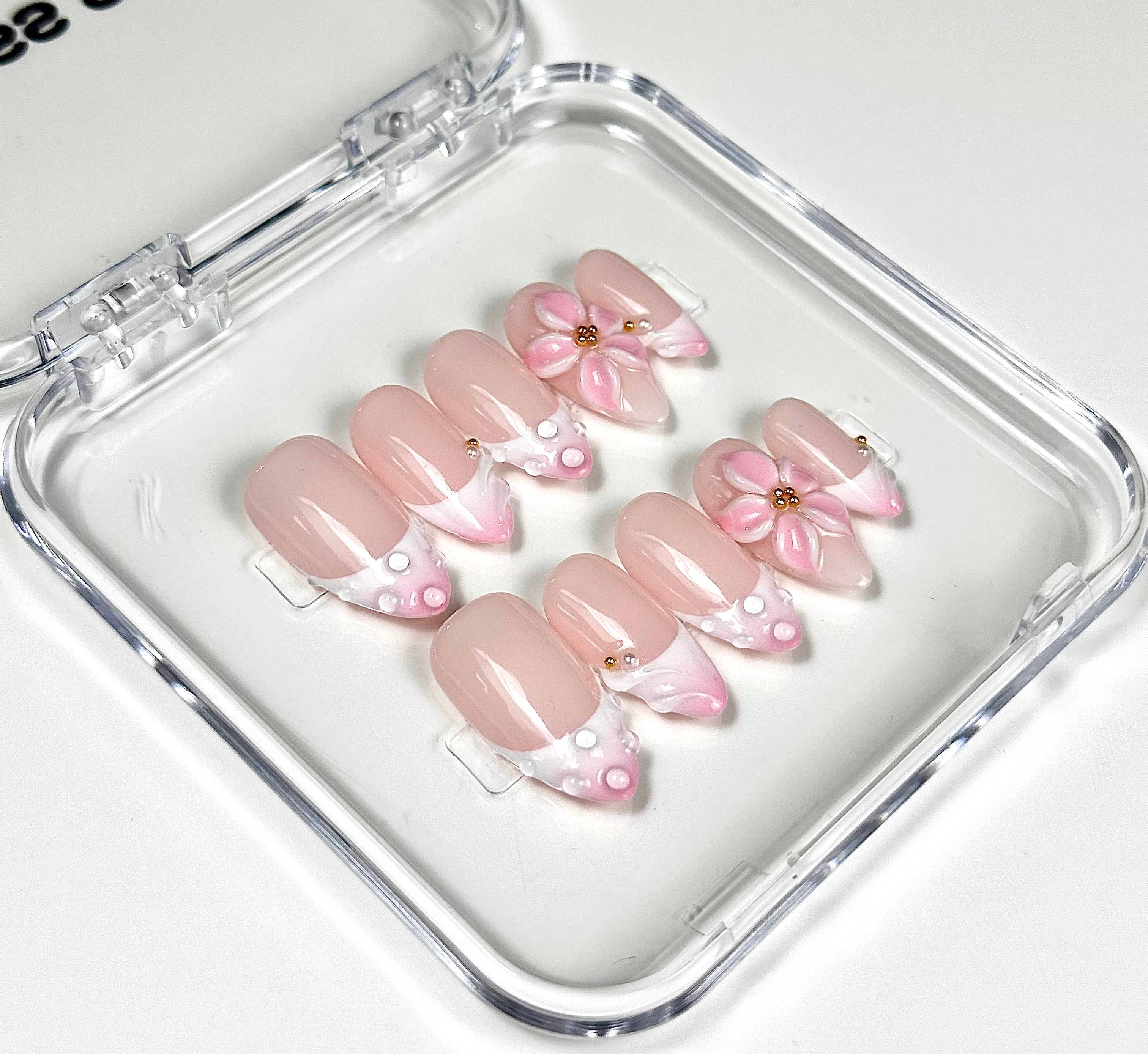 Set of pink and beige artificial nails with floral designs
