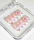 Set of pink and beige artificial nails with floral designs